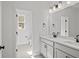 Bright bathroom features dual sink vanity, quartz countertop, modern fixtures, and tiled floors at 00 N Highway 17, McClellanville, SC 29458