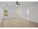 This bedroom features wood-look flooring, recessed lighting, a ceiling fan, and two large windows at 00 N Highway 17, McClellanville, SC 29458
