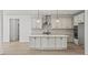 Modern white kitchen with island, stainless vent hood, and wood floors at 00 N Highway 17, McClellanville, SC 29458