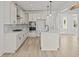 Modern kitchen with white cabinets, quartz countertops, stainless steel appliances, and island at 00 N Highway 17, McClellanville, SC 29458