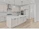 Stunning kitchen with island, stainless appliances, pendant lighting, and natural wood floors at 00 N Highway 17, McClellanville, SC 29458