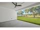 Covered patio with ceiling fan and a view of the green backyard with oak trees at 00 N Highway 17, McClellanville, SC 29458