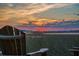 Sunset view framed behind Adirondack chairs in a waterfront community, offering a serene place to relax at 102 Mariners Cay Dr, Folly Beach, SC 29439