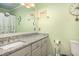 Bathroom featuring granite countertops, a decorative mirror, and a bathtub with shower at 102 Mariners Cay Dr, Folly Beach, SC 29439