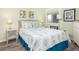 Cozy bedroom with a queen size bed with decorative pillows and a beachy theme at 102 Mariners Cay Dr, Folly Beach, SC 29439