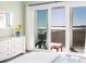 Bright bedroom with a sliding glass door leading to a balcony with ocean views at 102 Mariners Cay Dr, Folly Beach, SC 29439