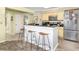 Stylish kitchen featuring breakfast bar, stainless steel appliances, and modern fixtures, ideal for culinary enthusiasts at 102 Mariners Cay Dr, Folly Beach, SC 29439