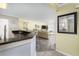 Bright, open-concept living area with a sleek kitchen, hardwood floors, and sliding glass doors to a balcony overlooking the water at 102 Mariners Cay Dr, Folly Beach, SC 29439