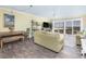 Relaxing living room featuring wood floors, neutral walls, water views, and comfortable seating for lounging and entertaining at 102 Mariners Cay Dr, Folly Beach, SC 29439