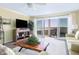 Bright living room with sliding glass doors opening to a balcony with water views, creating a relaxing space at 102 Mariners Cay Dr, Folly Beach, SC 29439