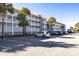 Exterior of the condo building with parking lot at 102 Mariners Cay Dr, Folly Beach, SC 29439