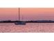 Beautiful sunset over the water with a sailboat, offering stunning views and a peaceful atmosphere at 102 Mariners Cay Dr, Folly Beach, SC 29439