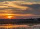 Scenic sunset view from the dock over the water, perfect for enjoying tranquil evenings at 102 Mariners Cay Dr, Folly Beach, SC 29439