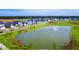 Aerial shot of a neighborhood surrounding a scenic lake and lush green space at 1033 Swamp Rose Run, Summerville, SC 29485