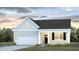 Charming one-story home featuring light siding, a covered porch, attached garage and well-maintained landscaping at 1034 Forrest Creek Dr, Summerville, SC 29483