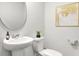 Elegant bathroom featuring a pedestal sink, round mirror, and modern fixtures at 1037 Swamp Rose Run, Summerville, SC 29485