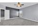 Carpeted bedroom features neutral and gray walls, a ceiling fan, and bright white trim at 1070 Moss Grove Dr, Moncks Corner, SC 29461