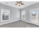Bedroom with neutral carpet, light-grey walls, fan, and door to an outdoor balcony at 1070 Moss Grove Dr, Moncks Corner, SC 29461
