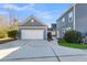 Detached garage with a well-maintained driveway and landscaping, complementing the home's exterior at 1070 Moss Grove Dr, Moncks Corner, SC 29461
