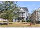 Inviting two-story home with a covered porch, complemented by neat landscaping and a fire hydrant at 1070 Moss Grove Dr, Moncks Corner, SC 29461