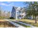 Charming two-story home featuring a welcoming front porch, and well-manicured lawn at 1070 Moss Grove Dr, Moncks Corner, SC 29461