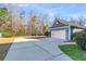 Detached two-car garage with a long concrete driveway and landscaping at 1070 Moss Grove Dr, Moncks Corner, SC 29461