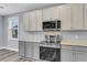 Modern kitchen with grey cabinets, stainless steel appliances, and light countertops at 1070 Moss Grove Dr, Moncks Corner, SC 29461