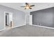 The main bedroom boasts plush carpet, gray accent walls, and a ceiling fan at 1070 Moss Grove Dr, Moncks Corner, SC 29461