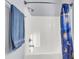 Clean white tile shower with towel rack and blue shower curtain at 1070 Moss Grove Dr, Moncks Corner, SC 29461