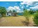 Landscaped backyard featuring a covered patio area, mature trees, and ample open space for various activities at 111 Carver St, Walterboro, SC 29488