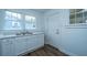 Bright kitchen features wood floors, double sink, and windows allowing natural light to fill the space at 111 Carver St, Walterboro, SC 29488