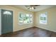 Sun-filled living room with a view of the yard, hardwood flooring, and updated ceiling fan at 111 Carver St, Walterboro, SC 29488