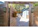 Charming backyard entrance through a wooden gate, showcasing the home's exterior and landscaped surroundings at 1117 Oceanview Rd, Charleston, SC 29412