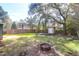 Large, fenced backyard featuring a fire pit and storage shed, perfect for outdoor activities and storage at 1117 Oceanview Rd, Charleston, SC 29412