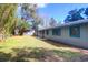 Spacious backyard featuring lush lawn, mature trees, and a charming screened-in porch, creating a serene outdoor space at 1117 Oceanview Rd, Charleston, SC 29412