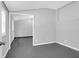 Well-lit bedroom featuring freshly painted walls, and sleek concrete flooring, and entrance to exterior at 1117 Oceanview Rd, Charleston, SC 29412