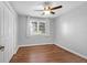 This bedroom features gray walls, wood floors, one window, white trim, and a ceiling fan at 1117 Oceanview Rd, Charleston, SC 29412