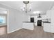 Open-concept kitchen with white cabinetry, black countertops, and stainless steel appliances at 1117 Oceanview Rd, Charleston, SC 29412
