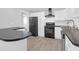 Well-equipped kitchen featuring white cabinets, black appliances, and updated flooring at 1117 Oceanview Rd, Charleston, SC 29412