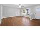 Spacious living room with hardwood floors, large windows, and a light gray painted walls at 1117 Oceanview Rd, Charleston, SC 29412