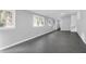 Bright living room featuring freshly painted walls, and sleek concrete flooring and natural light from the many windows at 1117 Oceanview Rd, Charleston, SC 29412