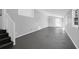Spacious living room featuring freshly painted walls, and sleek concrete flooring and natural light from many windows at 1117 Oceanview Rd, Charleston, SC 29412
