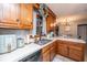 Bright and functional kitchen with wood cabinets, white countertops, and a view to the dining area at 112 Ravenswood Ct, Summerville, SC 29485