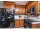 Efficient kitchen showcasing stainless steel appliances, warm wood cabinets, and ample counter space at 112 Ravenswood Ct, Summerville, SC 29485
