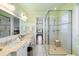 Bright bathroom with dual vanities, a large glass shower, and an adjoining room view at 1136 Ocean Forest Ln, Seabrook Island, SC 29455