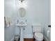 Powder room with a pedestal sink, decorative mirror, and blue walls at 1136 Ocean Forest Ln, Seabrook Island, SC 29455