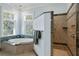 Bathroom with a soaking tub, tiled shower, and plenty of natural light at 1136 Ocean Forest Ln, Seabrook Island, SC 29455