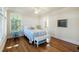 Comfortable bedroom with hardwood floors, a ceiling fan, a window and access to the bathroom at 1136 Ocean Forest Ln, Seabrook Island, SC 29455