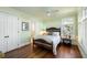 Light and airy bedroom features hardwood floors, a ceiling fan, and an en-suite bathroom at 1136 Ocean Forest Ln, Seabrook Island, SC 29455