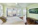 Comfortable bedroom with marsh views, wood floors, and access to an outdoor balcony for relaxation at 1136 Ocean Forest Ln, Seabrook Island, SC 29455